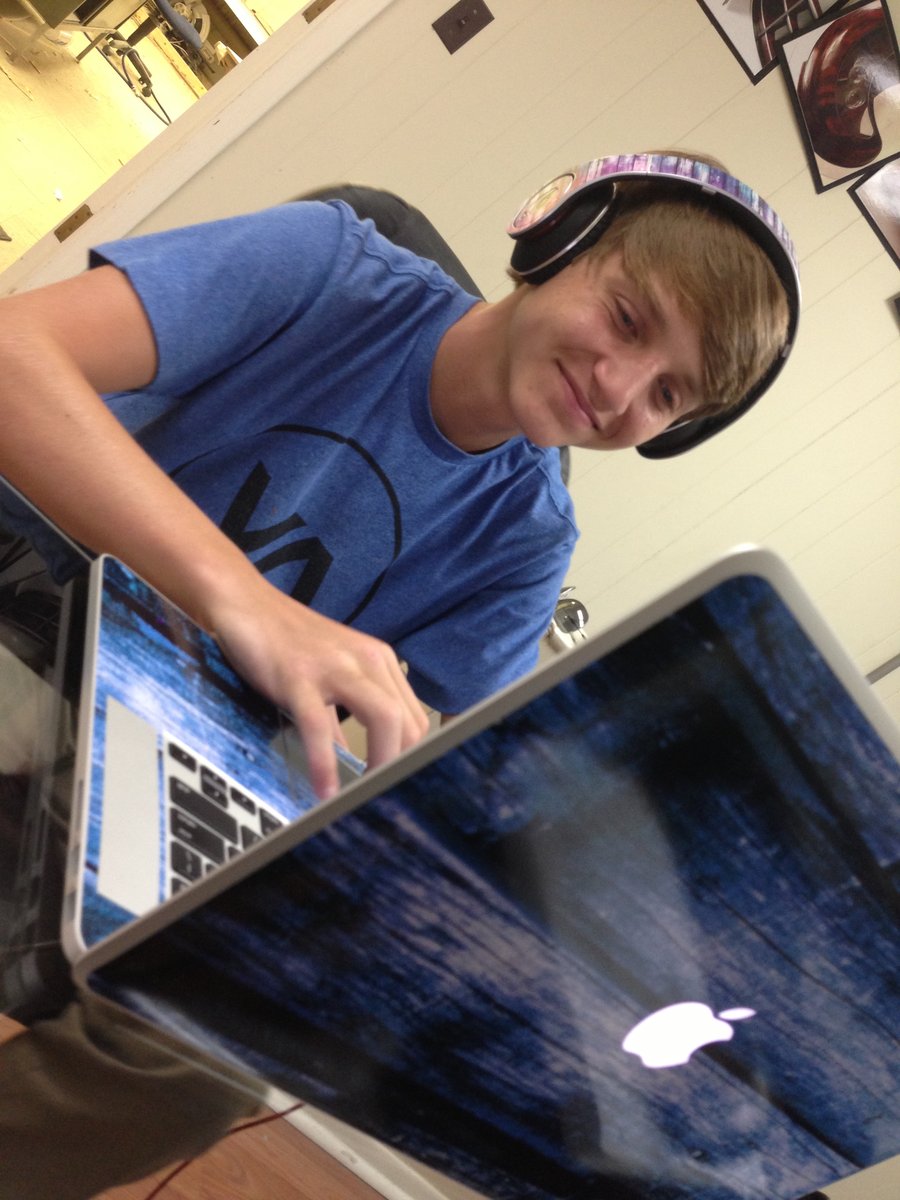 Austin designing on his laptop